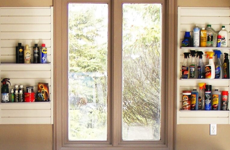 household supplies, on shelves by window above workstation at back of garage