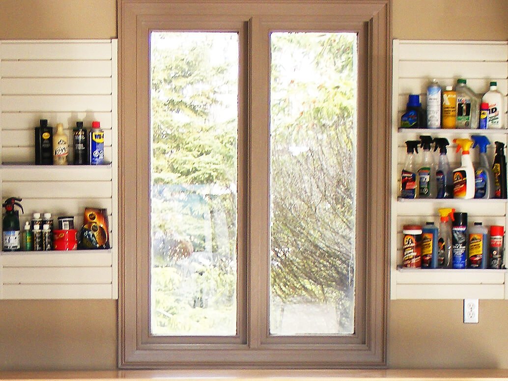 household supplies, on shelves by window above workstation at back of garage