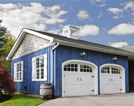 double car garage with white doors and blue exterior